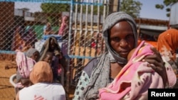 FILE - A Doctors Without Borders handout photo from January 2024 shows a woman and baby at the Zamzam displacement camp, close to El Fasher in North Darfur, Sudan. Fighting between RSF and the Sudanese Armed Forces appears ready to engulf the area. 