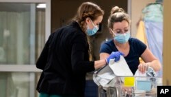 Nurses care for newborns at a hospital in Burlington, Vermont, April 28, 2023. Research found that babies born to opioid users had shorter hospital stays when their care emphasized parent involvement. (Ryan Mercer/University of Vermont Health Network via AP)