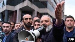 Protest leader Archbishop Bagrat Galstanyan speaks at a rally opposing a land transfer to Azerbaijan, in Yerevan, May 15, 2024. Armenia has returned to Azerbaijan four border villages it seized decades ago, the countries confirmed May 24, 2024.
