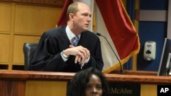 FILE - Judge Scott McAfee addresses lawyers during a hearing on charges against former President Donald Trump in the Georgia election interference case, in Atlanta, March 28, 2024. (Dennis Byron/Hip Hop Enquirer via AP)