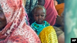 FILE - Sudanese refugees gather outside a field hospital in Acre, Chad, Aug. 15, 2023. The U.N. says about 25 million people — half of Sudan's population — need some form of humanitarian assistance.
