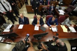 Former U.S. President Donald Trump sits in Manhattan criminal court, in New York, May 21, 2024.