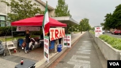 The National Solidarity Group for Iran activist group ends its two-week sit-in on a sidewalk near an entrance of the US State Department's Harry S Truman building in Washington on June 16, 2023. (Michael Lipin/VOA)