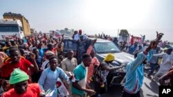 Rabi'u Musa Kwankwaso, presidential candidate of the New Nigerian Peoples Party, greets his supporters during a final election campaign rally in Kano Nigeria, Feb. 23, 2023. 