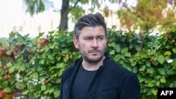 FILE - Russian author Dmitry Glukhovsky poses for a photograph Oct. 21, 2022, in Frankfurt am Main, Germany. A Russian court sentenced the writer to eight years in prison in absentia for denouncing Moscow's Ukraine offensive. 