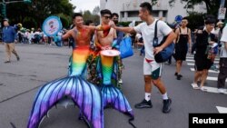 Friends greet each other at the annual Taiwan's Pride parade in Taipei, Taiwan, Oct. 28, 2023.