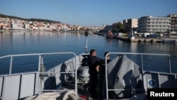 FILE - The Greek Coast Guard vessel 'Gavdos' prepares to moor following a night patrol, at the port of Mytilene, island of Lesbos, Sept. 30, 2019. Greece is a major entry point into EU for people fleeing conflict, poverty in the Middle East, Africa and Asia.