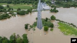 La Plata river floods a road after Tropical Storm Ernesto passed through Toa Baja, Puerto Rico, Aug. 14, 2024. 