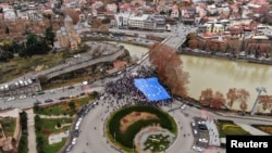 Participants carry a giant EU flag during a procession in support of Georgia's membership in the European Union in Tbilisi, Georgia, Dec. 9, 2023. 