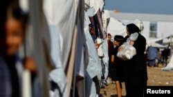 Palestinians, who fled their houses amid Israeli strikes, take shelter at a tent camp at a United Nations-run center, in Khan Younis in the southern Gaza Strip, Oct. 26, 2023. 