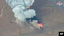 This photo taken from video released by the Russian Defense Ministry Press Service on March 13, 2024, shows destruction of a Ukrainian armed forces helicopter in the Donetsk region, eastern Ukraine. (Russian Defense Ministry Press Service via AP)