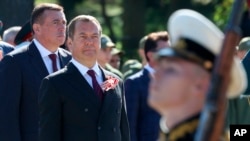 Russian Security Council Deputy Chairman and former President Dmitry Medvedev, second left, takes part in events marking Victory Day over Japan at the end of World War II, at a memorial in Yuzhno-Sakhalinsk, Russia, Sept. 3, 2023. (Ekaterina Shtukina/Sputnik pool photo via AP)
