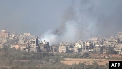 This picture taken from the Israeli border with the Gaza Strip shows smoke billowing over central Gaza following Israeli strikes on Dec. 31, 2023.