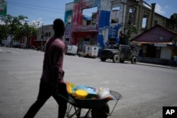 Police patrol in an armored vehicle in the Champ de Mars area of Port-au-Prince, Haiti, April 24, 2024.