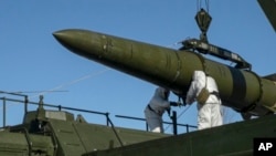 FILE - Russian troops load an Iskander missile onto a mobile launcher during drills at an undisclosed location in Russia, in this photo released by Russian Defense Ministry Press Service, Feb. 2, 2024.