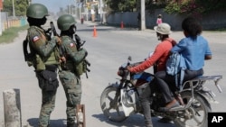 Soldiers patrol the road near the international airport in Port-au-Prince, Haiti, March 13, 2024.