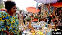 FILE - A woman shops at the Mvog Ada market in Yaounde, Cameroon, Jan. 29, 2022. During a protest on March 8, 2023, women asked the government to help them cope with price increases.