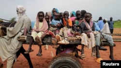 FILE - Sudanese children, who fled the conflict in Murnei in Sudan's Darfur region, ride a cart while crossing the border between Sudan and Chad in Adre, Chad, Aug. 4, 2023.