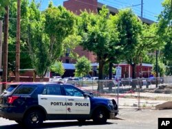 FILE - Portland Police respond to a shooting at the Legacy Good Samaritan Medical Center in Portland, Ore., July 22, 2023. Shootings and other attacks are increasing at hospitals across the U.S., helping to make health care one of the nation's most violent fields. (Maxine Bernstein/The Oregonian via AP, File) Keep aspect ratio