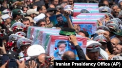 Flag-draped coffins of President Ebrahim Raisi and his companions who were killed in a helicopter crash on Sunday are carried during their funeral in Mashhad, Iran, May 23, 2024. 