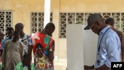 A voter marks his ballot in a voting booth at the Walia high school polling station in N'Djamena on May 6, 2024.