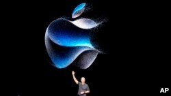 FILE - Apple CEO Tim Cook waves as he walks to the stage during an announcement of new products on the Apple campus, Sept. 12, 2023, in Cupertino, California. 