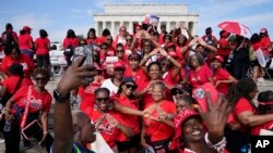 Members of Delta Sigma Theta Sorority Inc. pause for a photo in front of the Lincoln Memorial in Washington while they commemorate the 60th anniversary of the March on Washington for Jobs and Freedom, Aug. 26, 2023.