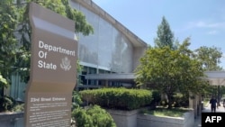 FILE — Signage is seen outside one of the entrances of the U.S. Department of State in Washington, Aug. 6, 2021. The United States said Monday it would resume sales of offensive weapons to Saudi Arabia.