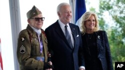 President Joe Biden and first lady Jill Biden, greet a World War II veteran during ceremonies to mark the 80th anniversary of D-Day, June 6, 2024, in Normandy. 