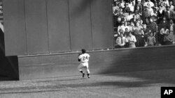 FILE - New York Giants' Willie Mays catches a ball hit by Cleveland Indians' Vic Wertz in Game 1 of the 1954 baseball World Series in New York's Polo Grounds, Sept. 29, 1954.