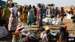 FILE - Internally displaced women wait for food rations to be distributed by the World Food Program in Bentiu, South Sudan, Feb. 6, 2023.