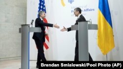 U.S. Secretary of State Antony Blinken, left, steps forward to shake hands with Ukrainian Foreign Minister Dmytro Kuleba during a press conference in Kyiv, Ukraine, May 15, 2024. (Brendan Smialowski/Pool Photo via AP)