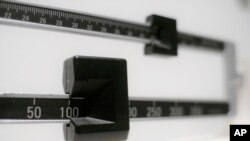 FILE- A close-up of a beam scale is seen in New York, April 3, 2018. 