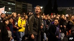 Demonstrators shout anti-government slogans during a protest in front of the parliament, in Athens, March 3, 2023.