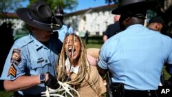 Georgia State Patrol officers detain a demonstrator on the campus of Emory University during a pro-Palestinian demonstration, April 25, 2024, in Atlanta.