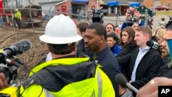 EPA Administrator Michael Regan, center, answers questions at Sulphur Creek in East Palestine, Ohio, Feb. 16, 2023. Residents wanted to know if they were safe from toxic chemicals that spilled or were burned off after a train derailment.