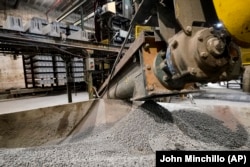 Excess material from freshly made concrete blocks, created with liquid carbon dioxide as an ingredient, is collected for reprocessing at the Glenwood Mason Supply Company, Tuesday, April 18, 2023, in the Brooklyn borough of New York. New York is forcing buildings to clean up, and several are experimenting with capturing carbon dioxide, cooling it into a liquid and mixing it into concrete where it turns into a mineral. (AP Photo/John Minchillo)