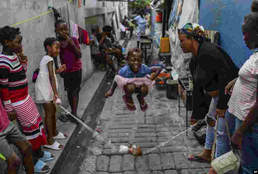 A girl plays a jump rope game at a school housing residents displaced by gang violence in Port-au-Prince, Haiti, May 15, 2024.