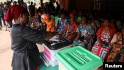 A voter casts her ballot during Nigeria's Presidential election, in Agulu, Anambra state, Nigeria, Feb. 25, 2023.