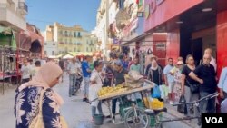 Tunisians wait in line for bread. Subsidized staples like flour and milk are sometimes hard to find. (Lisa Bryant/VOA)