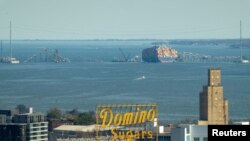 Salvage cranes on barges are anchored at the wreckage of the Francis Scott Key Bridge over the Patapsco River, which collapsed after it was struck by a container ship, in Baltimore, Maryland, March 31, 2024. (Jasper Colt/USA Today Network via Reuters)