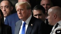 FILE - Former President Donald Trump walks out of the courtroom to make comments to members of the media after a jury convicted him of felony crimes for falsifying business records, at Manhattan Criminal Court, in New York, May 30, 2024. 