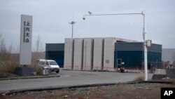 FILE - An SAIC Volkswagen plant is seen in the outskirts of Urumqi in China's Xinjiang Uyghur Autonomous Region, April 22, 2021. Volkswagen is being pressed to detail plans to eliminate alleged Uyghur forced labor from its supply chains.