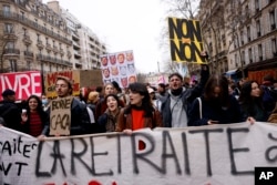 Protesters march during a demonstration in Paris, March 15, 2023.