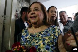 Substitute opposition presidential candidate Corina Yoris exits a press conference accompanied by opposition leader opposition leader Maria Corina Machado, in Caracas, Venezuela, March 22, 2024.