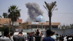 Smoke rises following an Israeli airstrike in Deir al Balah, Gaza Strip, April 23, 2024. 