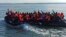 This photo provided by the Prefecture Maritime du Nord et de la Manche shows migrants continuing their journey to Britain off the northern coast of France, April 23, 2024. 