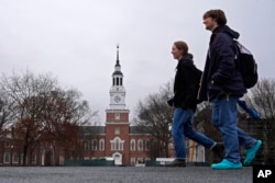 FILE - Students cross the campus of Dartmouth College, on March 5, 2024, in Hanover, N.H. Americans are increasingly skeptical about the value and cost of college. (AP Photo/Robert F. Bukaty, File)
