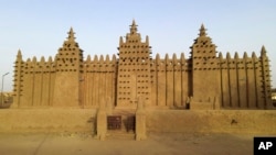 FILE- The world's largest mud-brick building, the Great Mosque of Djenne, Mali, awaits its annual replastering, May 10, 2024. 