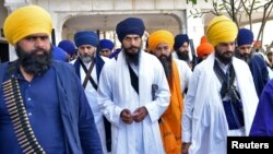 FILE - Amritpal Singh, a separatist Sikh leader, leaves the holy Sikh shrine of the Golden Temple along with his supporters, in Amritsar, India, March 3, 2023.
